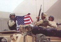 PHOTO CREDIT:  Soldiers with flag:  Brant Sanderlin - Atlanta Journal-Constitution